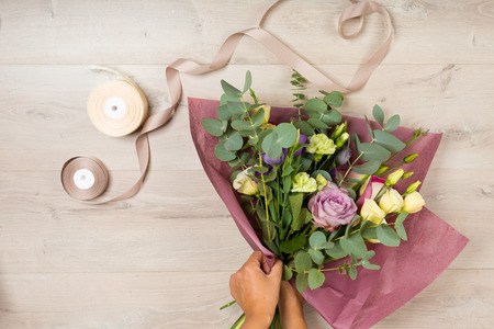 Flowers and floristic equipment arranged on a wooden backgroundの写真素材