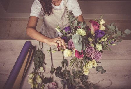 Flowers and floristic equipment arranged on a wooden background