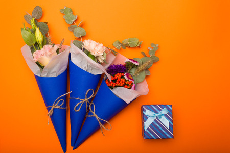 Lovely bouquet in a paper cone with a gift bagの写真素材
