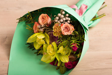 Flowers in a gift box on a wooden backgroundの写真素材
