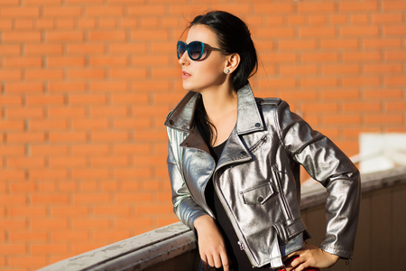 Stylish woman in silver leather jacketの写真素材
