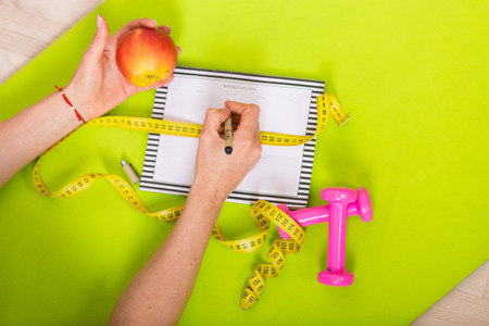 Woman working with a weekly plannerの写真素材