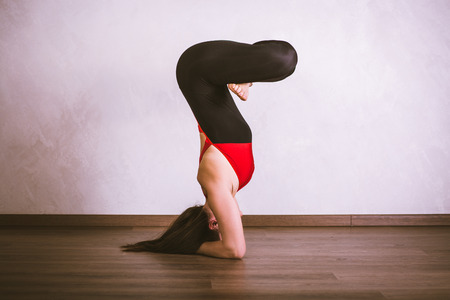 Pretty woman practicing yoga at home
