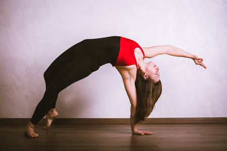 Pretty woman practicing yoga at home