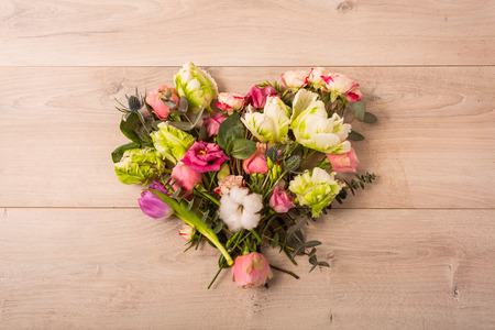 Flat lay of flowers and plants on the wooden backgroundの写真素材