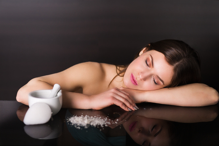 Pretty young woman with skin care productsの写真素材