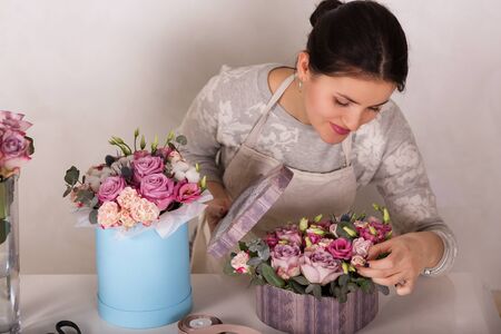 Beautiful florist working in a flower shopの写真素材