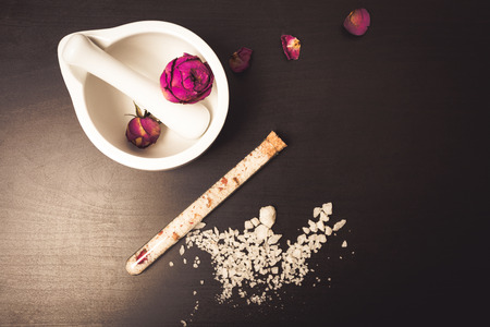 Skincare treatment and flowers on a black backgroundの写真素材