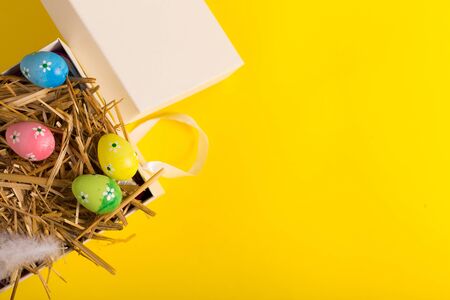 Colorful Easter eggs on a yellow background