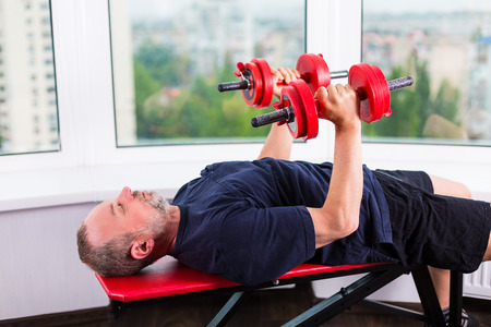 Senior man working out at the gymの写真素材