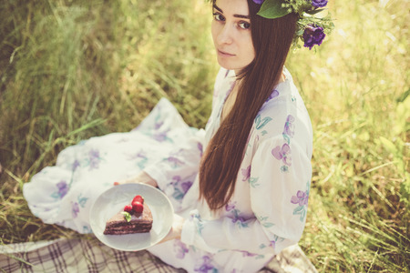 Beautiful woman with a desert having a summer picnicの写真素材