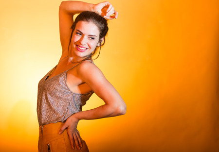 Beautiful woman dancing and posing in bright disco lights