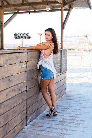 Woman at the beach bar ordering cocktailsの写真素材