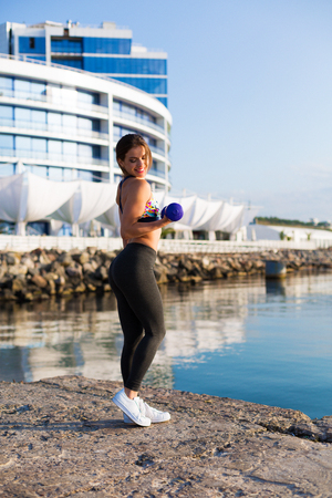 Woman working out on a summer the beachの写真素材