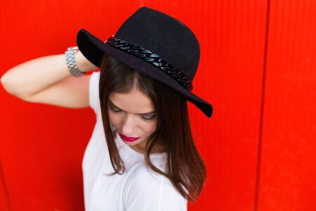 Stylish woman with black wool hat standing on the street