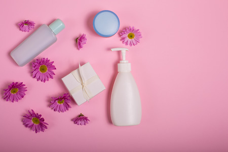 Cosmetics and flowers on a pink backgroundの写真素材