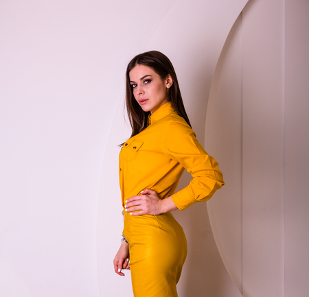 Beautiful woman in yellow shirt and skirtの写真素材