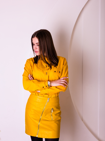 Beautiful woman in yellow shirt and skirtの写真素材