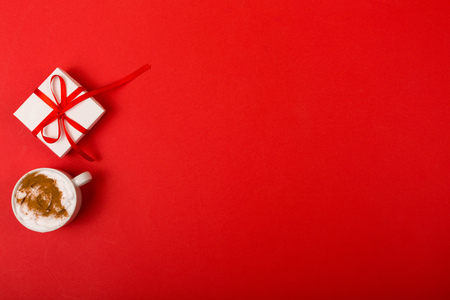 Present and deserts on a bright red background with a copy spaceの写真素材