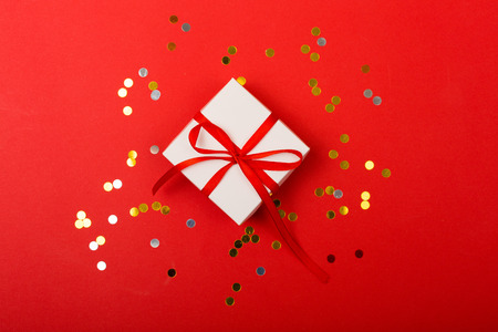 Present on a bright red background with a copy spaceの写真素材