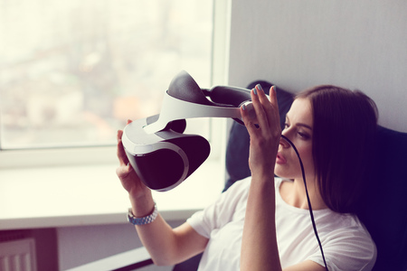 Young woman holding a VR headset