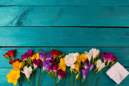 Bouquet of freesia flowers on a blue wooden backgroundの写真素材