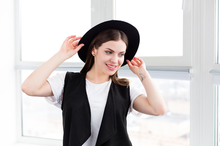 Beautiful smiling woman with a wool hat in a studioの写真素材