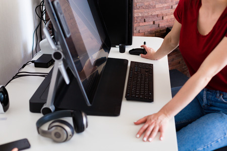 Young woman working at the computer in a modern office