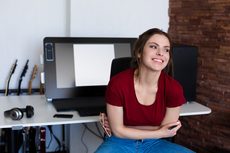 Young woman working at the computer and digital tabletの写真素材