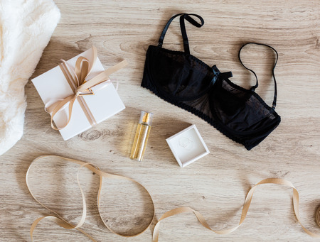 Woman's accessories with a gift box on a wooden backgroundの写真素材