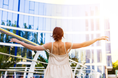 Beautiful young woman walking in the summer cityの写真素材
