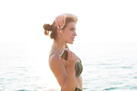 Young woman working out at the beach in the summerの写真素材