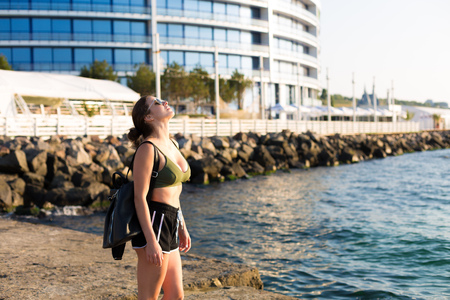 Young woman working out at the beach in the summerの写真素材