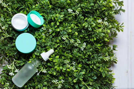Variety of organic cosmetics on a green spring grass backgroundの写真素材