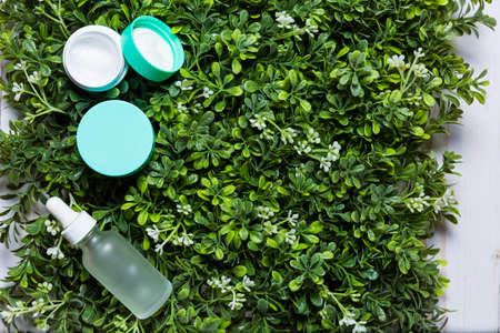 Variety of organic cosmetics on a green spring grass backgroundの写真素材