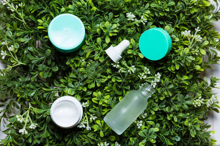 Variety of organic cosmetics on a green spring grass backgroundの写真素材