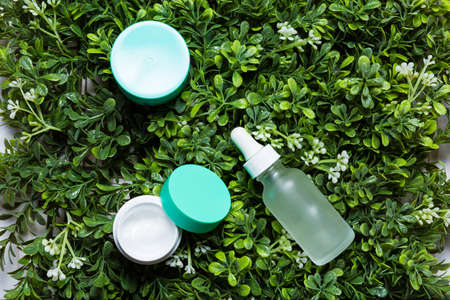 Variety of organic cosmetics on a green spring grass backgroundの写真素材