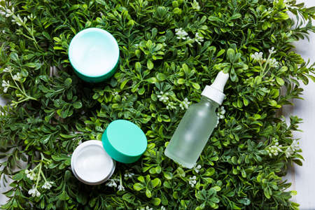 Variety of organic cosmetics on a green spring grass backgroundの写真素材