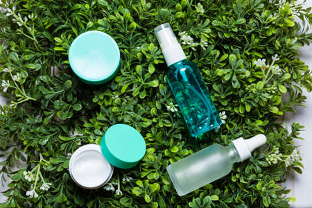 Variety of organic cosmetics on a green spring grass backgroundの写真素材