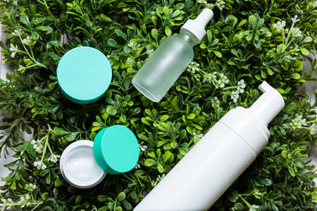 Variety of organic cosmetics on a green spring grass backgroundの写真素材