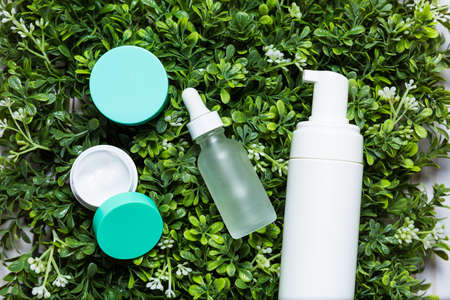 Variety of organic cosmetics on a green spring grass backgroundの写真素材