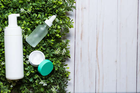 Variety of organic cosmetics on a green spring grass backgroundの写真素材