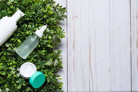 Variety of organic cosmetics on a green spring grass backgroundの写真素材