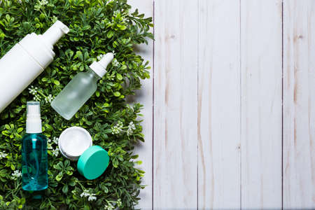 Variety of organic cosmetics on a green spring grass backgroundの写真素材