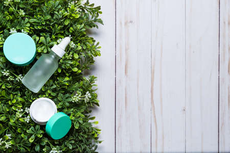 Variety of organic cosmetics on a green spring grass backgroundの写真素材