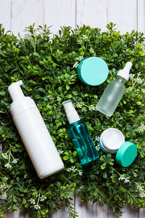 Variety of organic cosmetics on a green spring grass backgroundの写真素材