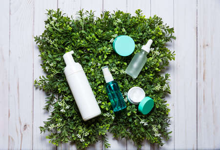 Variety of organic cosmetics on a green spring grass backgroundの写真素材