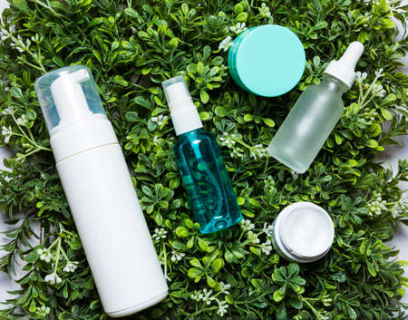 Variety of organic cosmetics on a green spring grass backgroundの写真素材