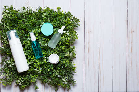 Variety of organic cosmetics on a green spring grass backgroundの写真素材