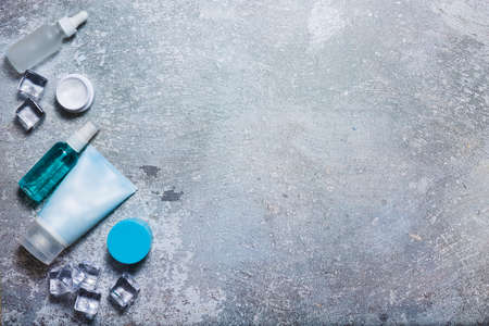 Cosmetics on a concrete background with ice cubesの写真素材